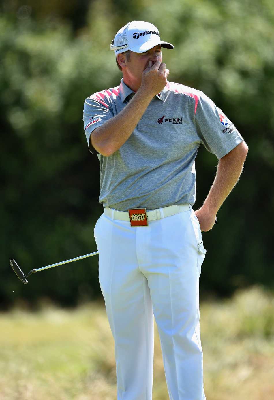 果岭风云与球场众生相高尔夫赛场上的荣耀悲欢与生活缩影 波恩茨在果岭上屈膝仔细观察推杆线路,神情专注如侦探勘察现场