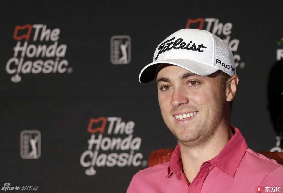 镜头特写高尔夫球落在修剪完美的果岭环上，背景是宽阔的球道和远处的水障碍，展现球场卓越的养护品质与挑战性。