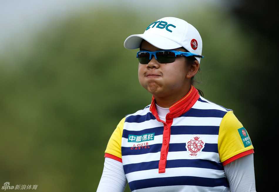 多莉-卡特正弯腰认真查看果岭推杆线，她的目光如尺，精准地丈量着草纹的每一丝起伏，寻找小球进洞的最佳路径。