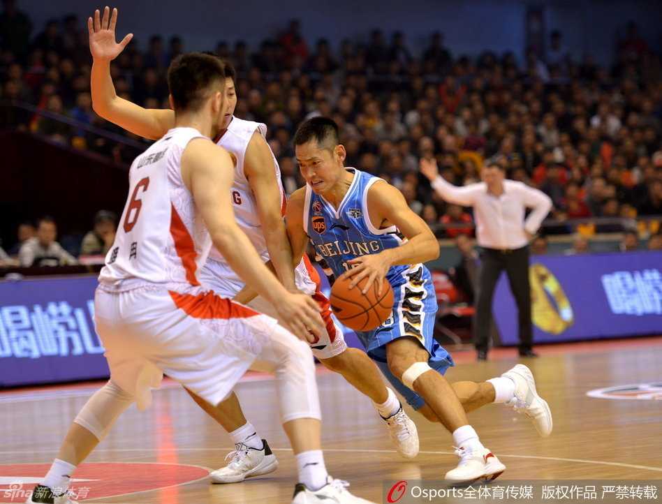 张庆鹏在三分线外面对防守球员，眼神坚毅，手腕轻轻拨出皮球，划出一道完美弧线。