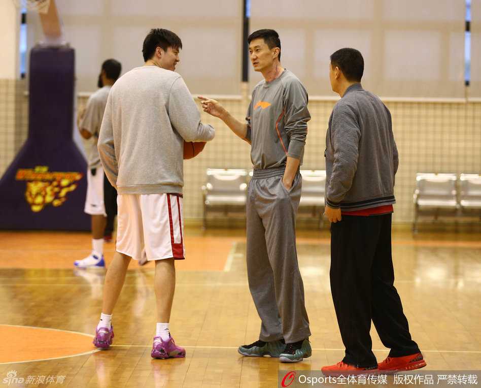 朱芳雨在三分线外接球跳投，出手点依然如巅峰期般标准，球在空中旋转，背景虚化处是周鹏同样在专注投篮的身影。