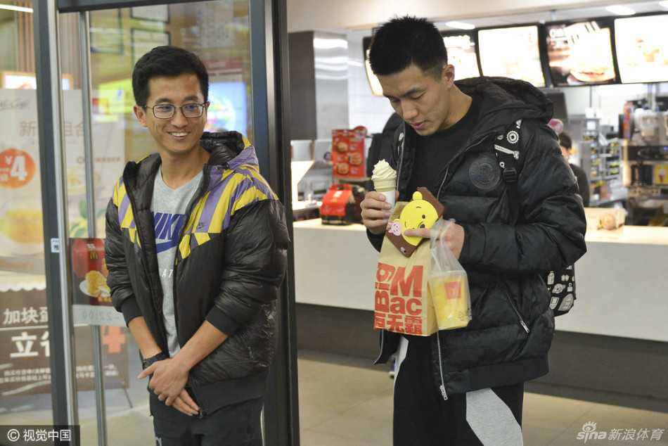 一位可爱的小球迷穿着迷你版的郭艾伦球衣，在人潮中兴奋地挥舞着手臂，眼神里满是对偶像的崇拜。