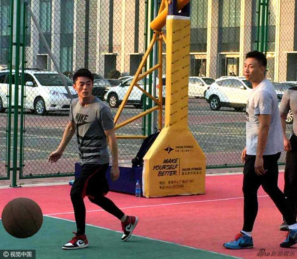 霍建华眼神如鹰，弯下腰身紧紧跟防对手，黑色的衣角在风中扬起，仿佛一位在战场上寸土不让的骁将。