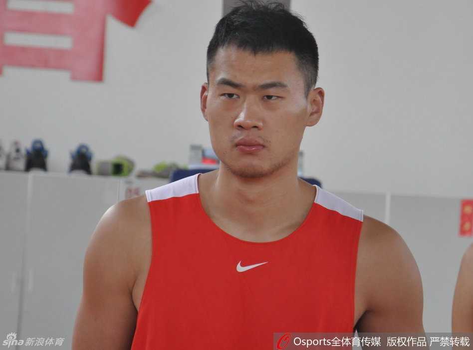 丁彦雨航在底角稳稳出手三分，篮球在空中划出完美弧线，背景是山东男篮训练馆的落地窗，阳光洒在地板上。