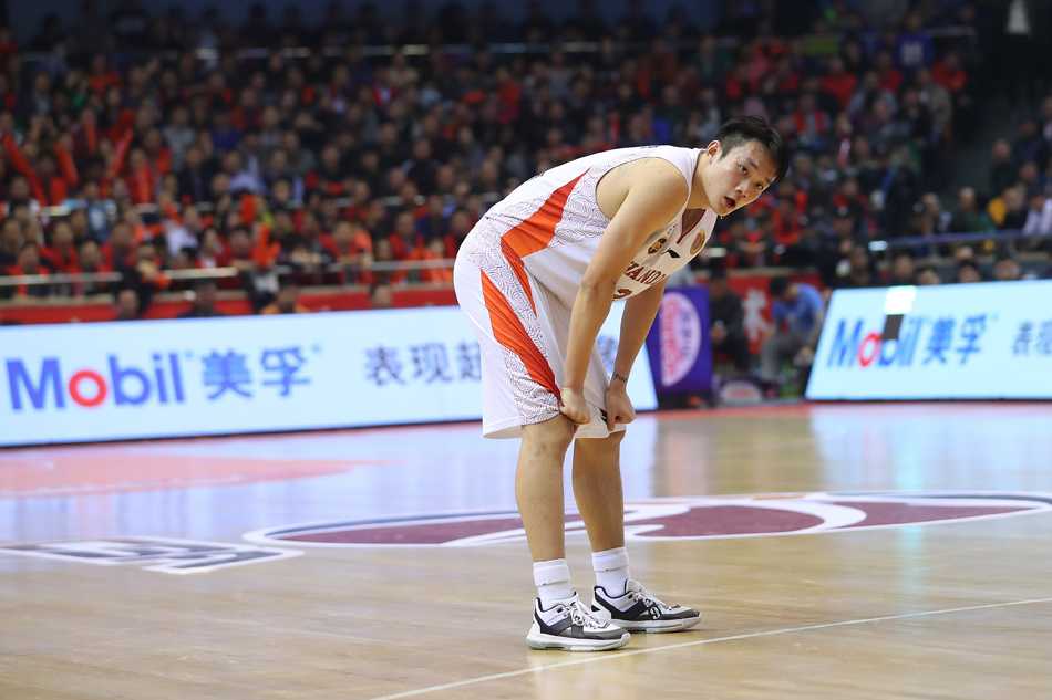 丁彦雨航从颁奖嘉宾手中接过象征荣耀的MVP奖杯，眼神中闪烁着自信与坚毅，全场球迷起立为他欢呼。