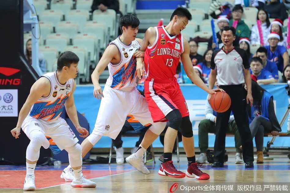 广州队球员紧紧相拥，庆祝这场来之不易的客场胜利，背景是上海队球员落寞的身影。