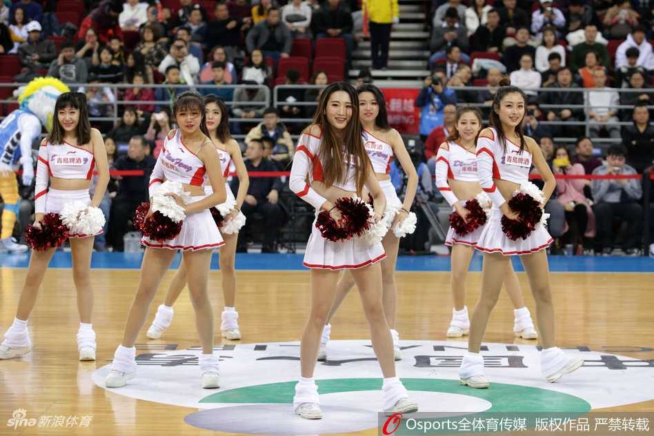 舞台背景的蓝色灯光如梦似幻，几位篮球宝贝背对背摆出酷炫的造型，她们的手臂线条流畅而有力，展现出新时代女性特有的健康美与自信风采。