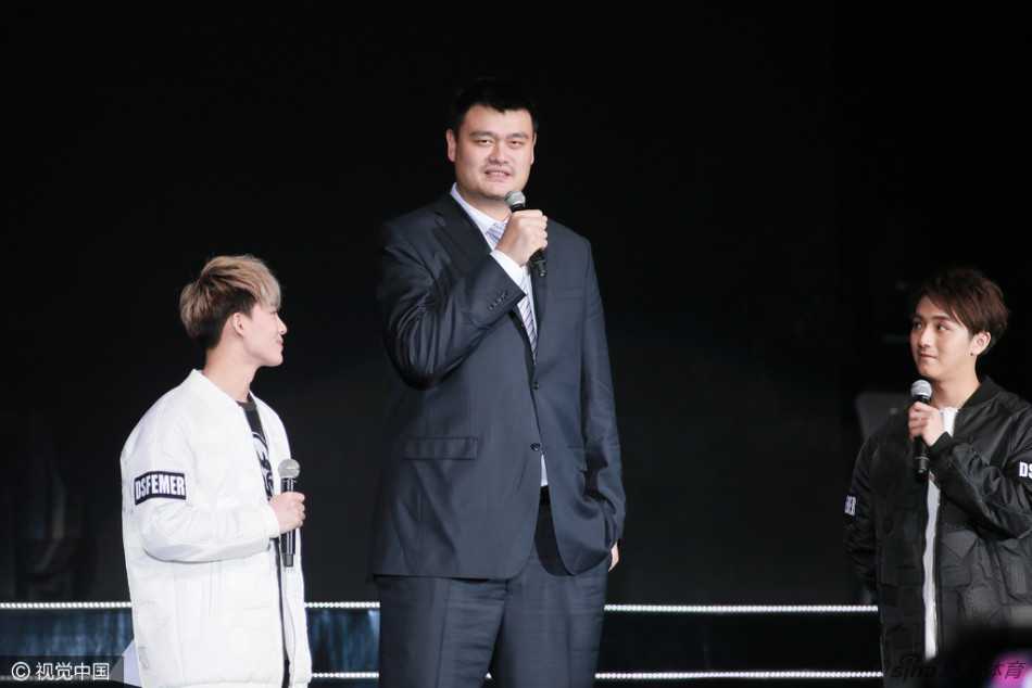 在璀璨的舞台灯光下，巨人姚明手持麦克风，面带谦逊微笑，为香港演唱会开场，仿佛将球场上的从容带到了音乐的殿堂。