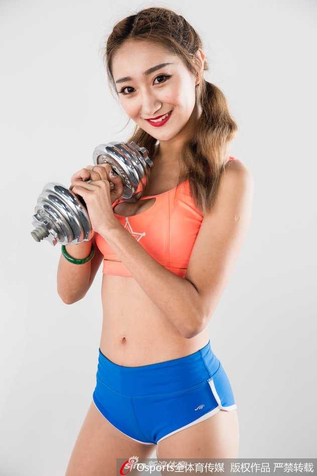 镜头拉近，宝贝额头渗出细汗，专注的眼神和紧实的马甲线，在哑铃的衬托下格外迷人