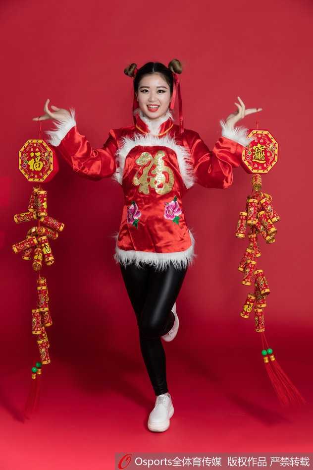 盛装打扮的篮球宝贝侧身回眸，中国红的上衣与精致的妆容在光影下格外明艳，展现了古典与现代交织的独特气质。