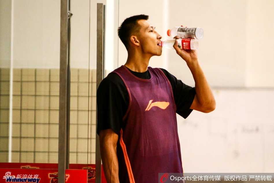 训练场上，易建联神情专注，目光如炬，在助教的协助下进行拉伸，肌肉线条分明，仿佛一头蓄势待发的猛兽，随时准备撕裂对手的防线。