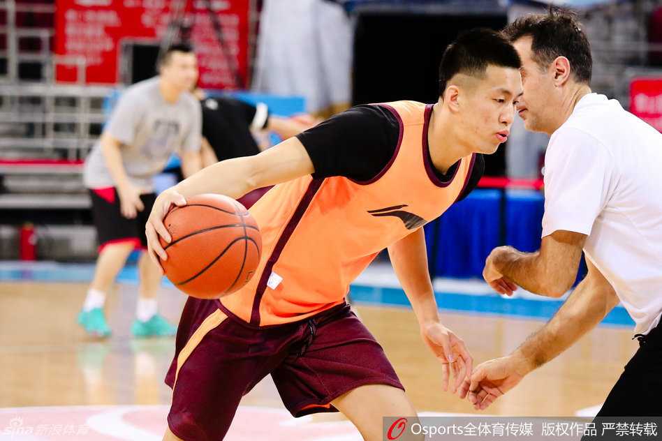 主教练郭士强双手抱胸，在场边全神贯注地监督着弟子们的每一个动作，神情严肃中带着一丝期许。