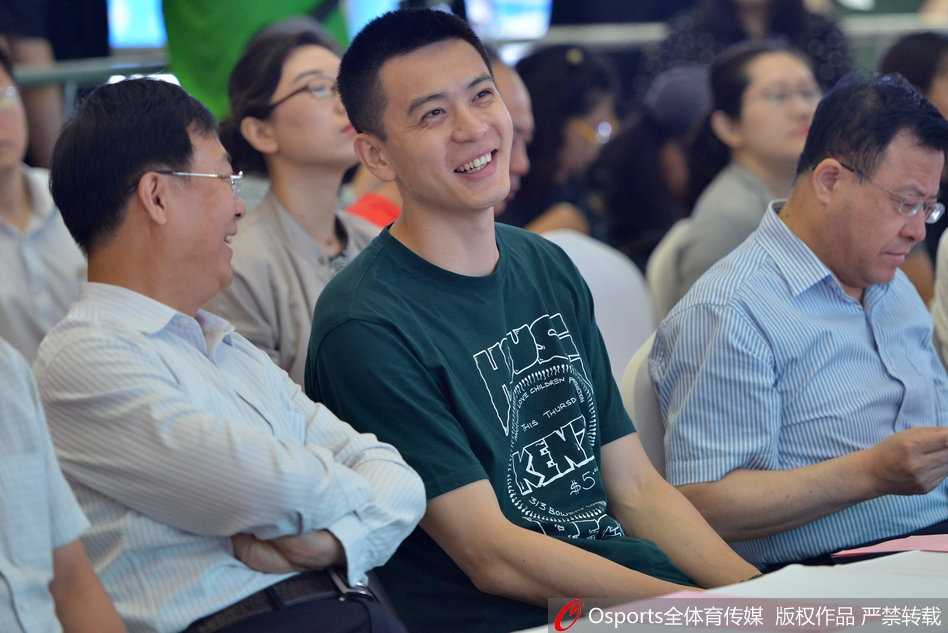 活动现场杨鸣手持写有垃圾名称的卡片，神情专注地思考应投入哪个分类垃圾桶